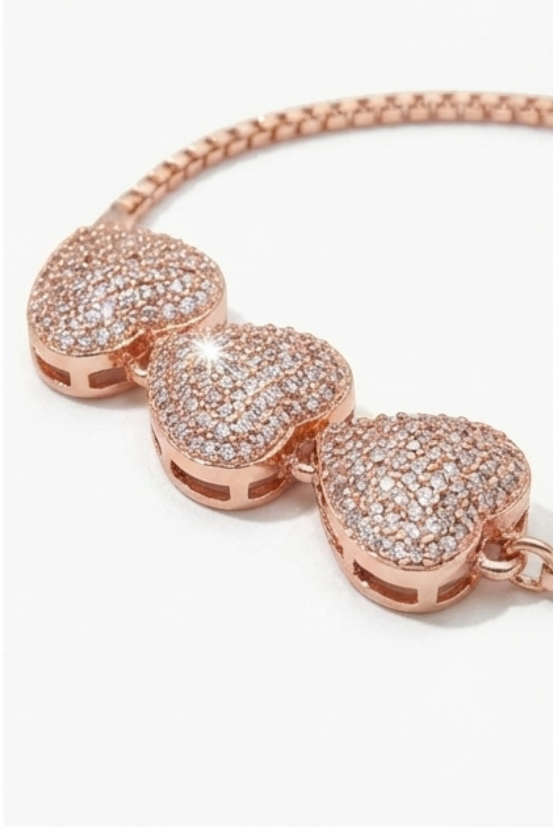 dazzle21 rose gold-tone triple heart bracelet with pavé crystal stones and an adjustable sliding bolo clasp